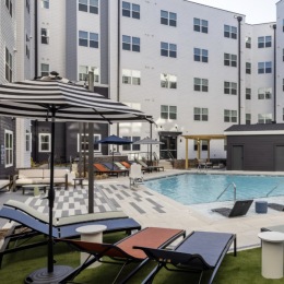 pool area showing reclining seating, wooden coverings and ample space